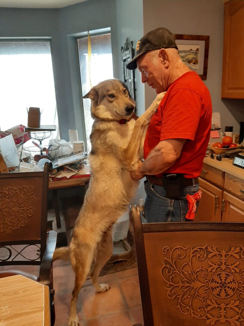 A man and his dog in the kitchen